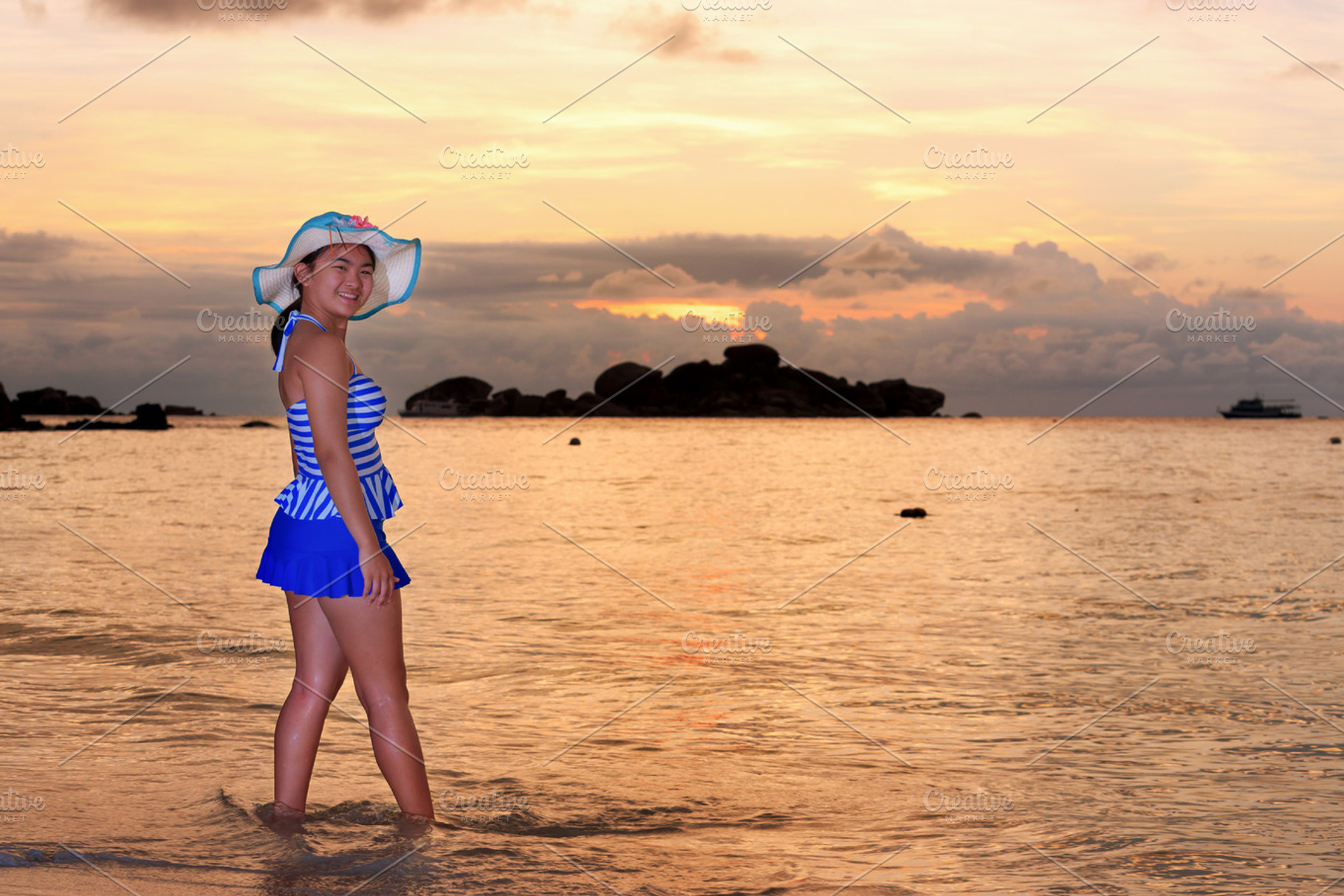 Girl on the beach at sunrise stock photo containing beach and sea, a Person Photo by yongkiet jitwattanatam