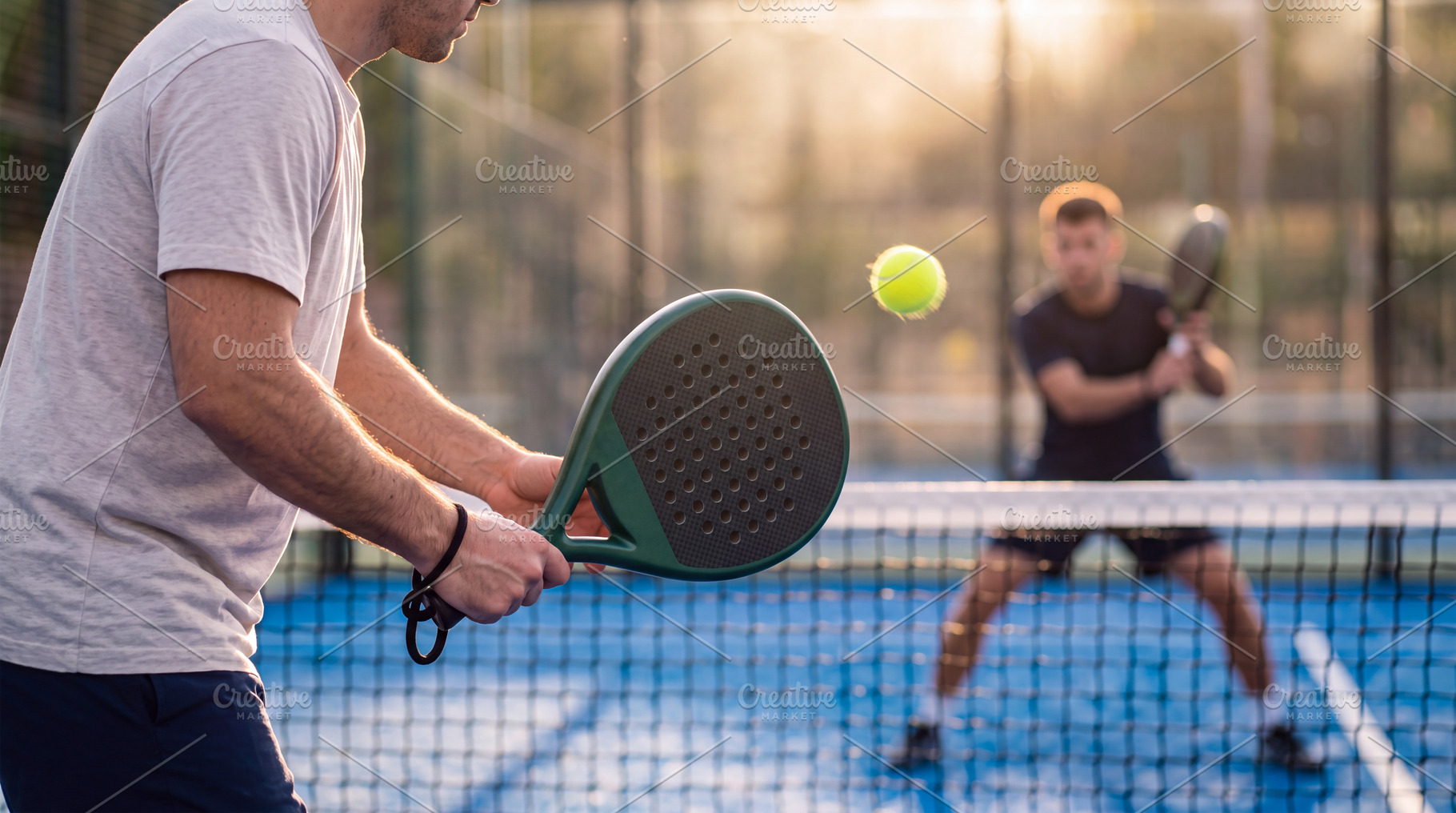 Action shot of padel player hitting a serve with ball floating i, a Sports & Recreation Photo by Volff