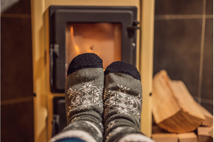 Feet in winter socks are heated by, a Holiday Photo by Elizaveta Galitskaya