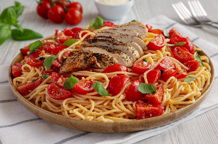 Homemade Bruschetta Chicken Pasta on a Plate, side view., a Food & Drink Photo by LiudmylaChuhunova