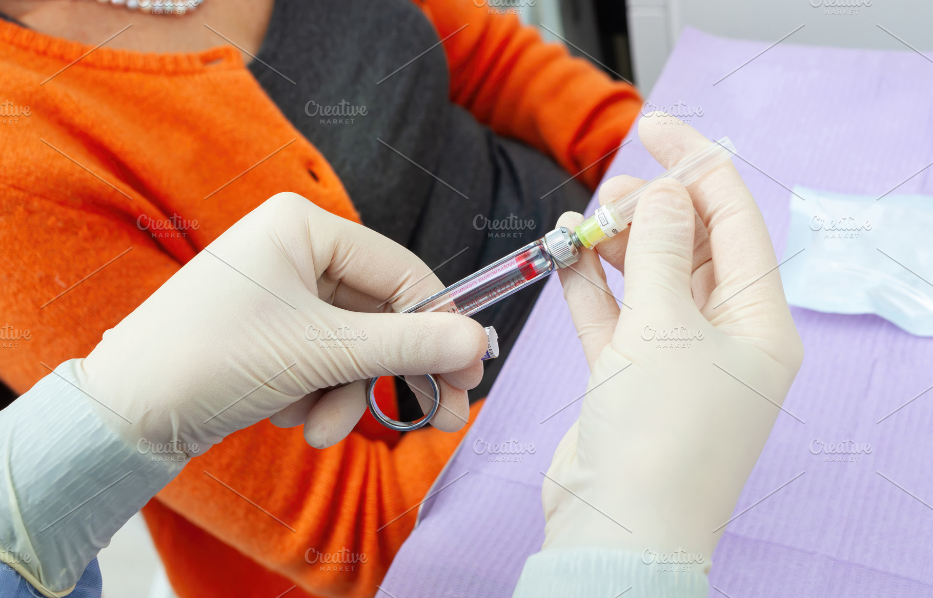 Doctor preparing syringe for injection to mature adult patient, a Health & Medical Photo by Antonio Gravante Market