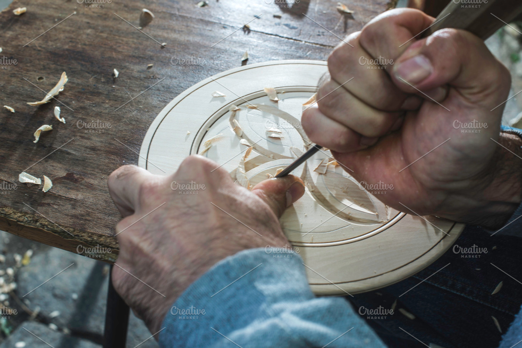 Hands of woodcarver make ​​wooden bo featuring wood, woodcarving, and craft, an Arts & Entertainment Photo by Deyan Georgiev