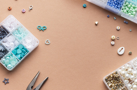 Crafting with colorful beads on a flat workspace with tools and, an Arts & Entertainment Photo by Olena Rudo