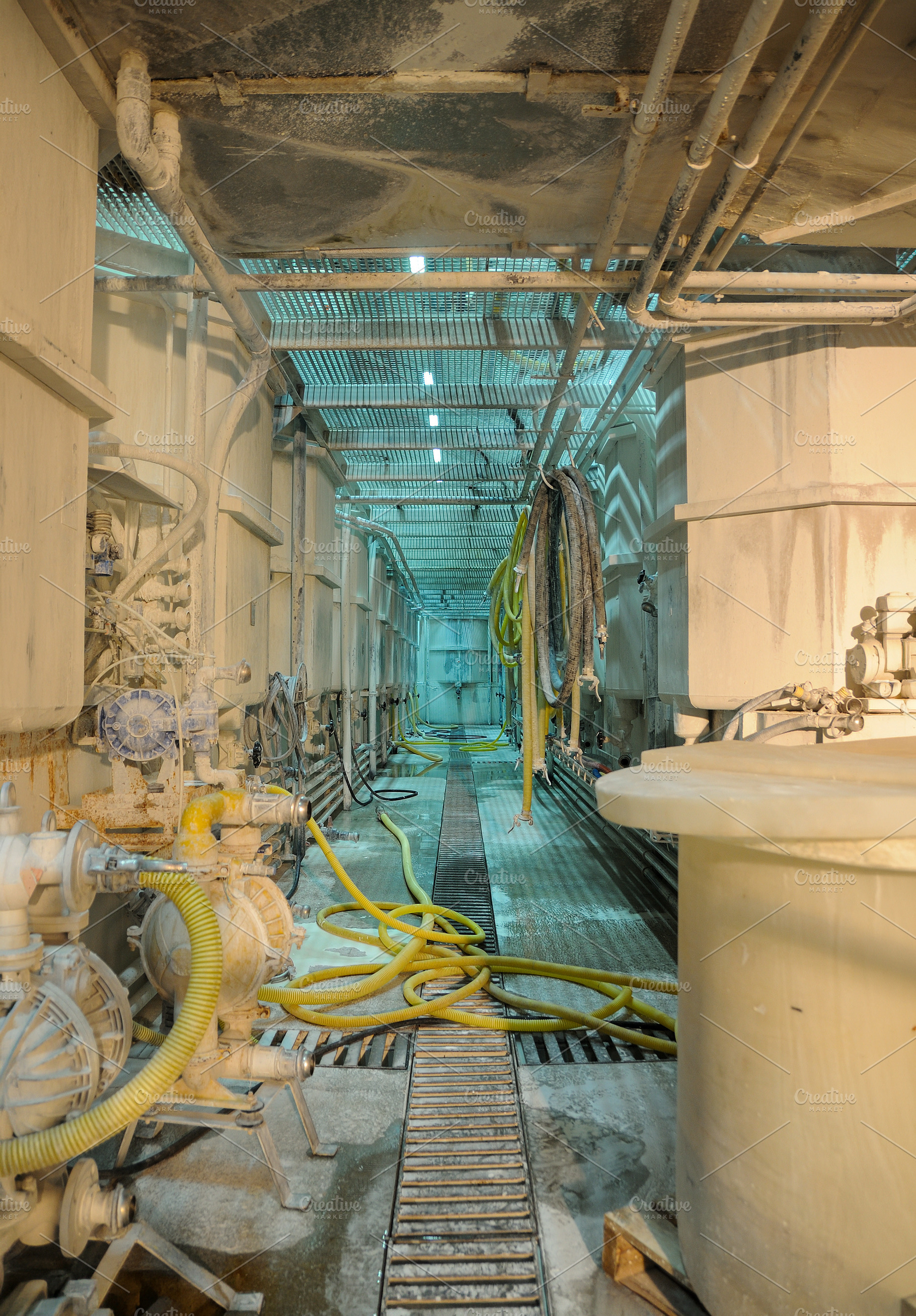 Industrial Processing Corridor with Pipes and Chemical Tanks, an Industrial Photo by Davizro's Market
