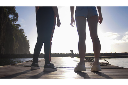 Two young athletic women stand on, a Photo by Barcelona_dreams