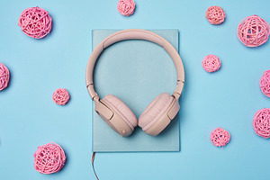 Pink wireless headphones in the center and pink decorative ratta, a Technology Photo by ndanko