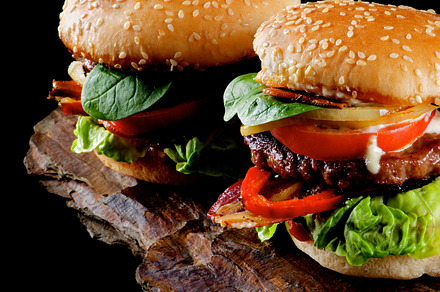 Two tasty hamburgers featuring abundance, bacon, and basil, a Food & Drink Photo by zhekos