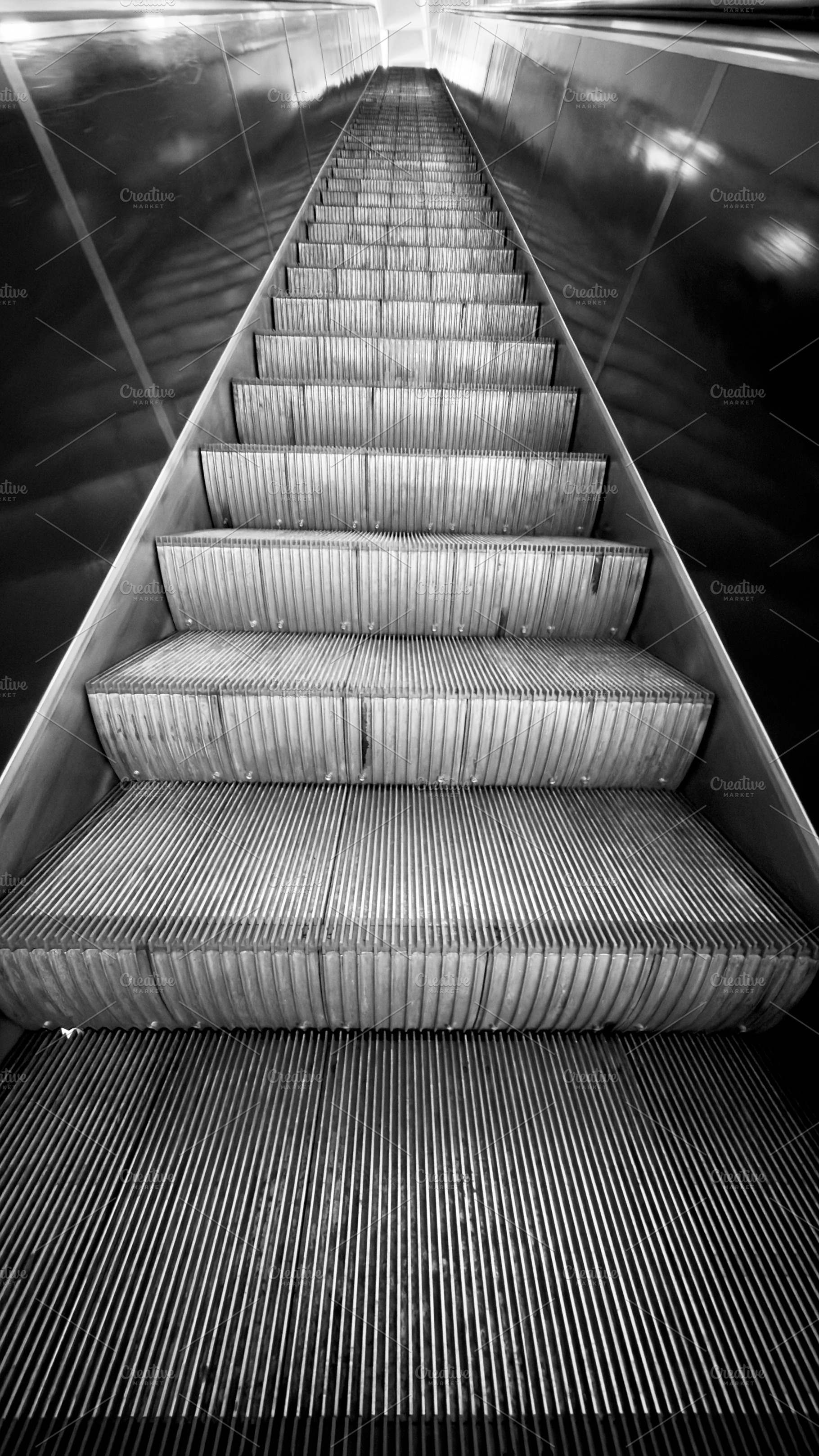 A close-up view of escalator steps in black and white, showcasing the texture a, an Industrial Photo by Textures & Backgrounds