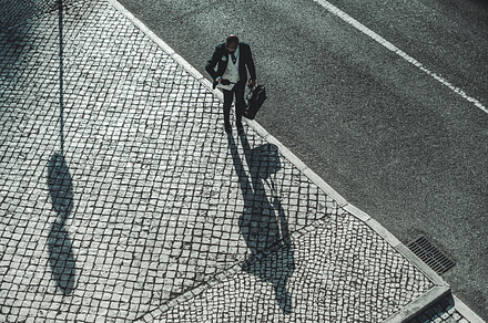African man on the the sidewalk, a Person Photo by SkyNext