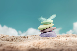 Calm and stable mindset.Balanced colorful stones and feather on, a Photo by salmon.black