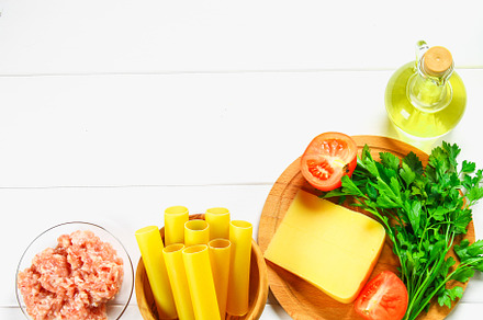 Italian pasta cannelloni raw tube for stuffing stuffing surrounded by, a Food & Drink Photo by Detriana