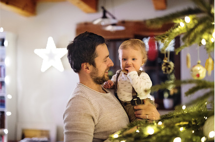 Father showing christmas tree to, a Holiday Photo by HalfPoint