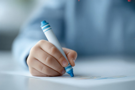 Focused student working on colorful drawing in classroom