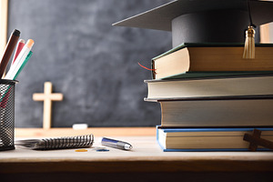 Stack of educational books and a mortarboard on desk, a School & Education Photo by Davizro's Market
