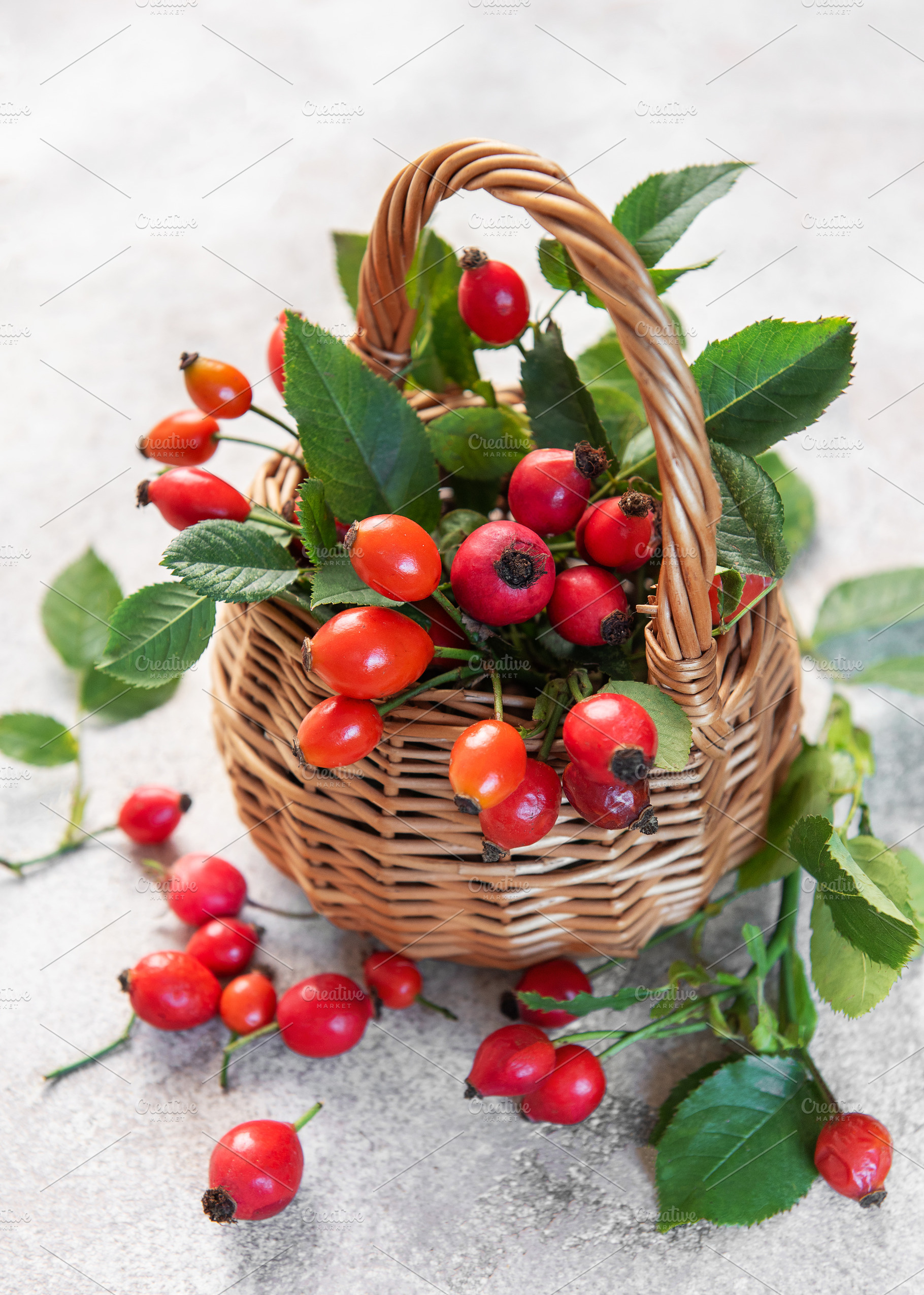 Wicker basket overflowing with freshly picked rose hips and gree, a Food & Drink Photo by Olena Rudo
