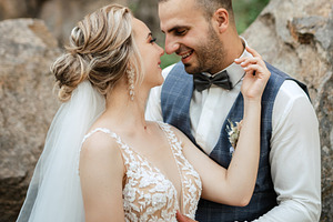 the groom and the bride are walking in the forest, a Person Photo by Weddings, People, Travel