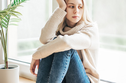 Sad girl near window thinking about something, a Person Photo by Olena Rudo