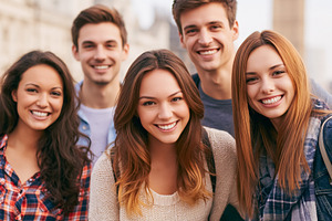 Group of smiling young people standing together outdoors, experi, a Photo by Studio ANNA