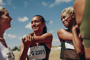 Women runners doing warmup exercises, a Person Photo by Jacob Lund