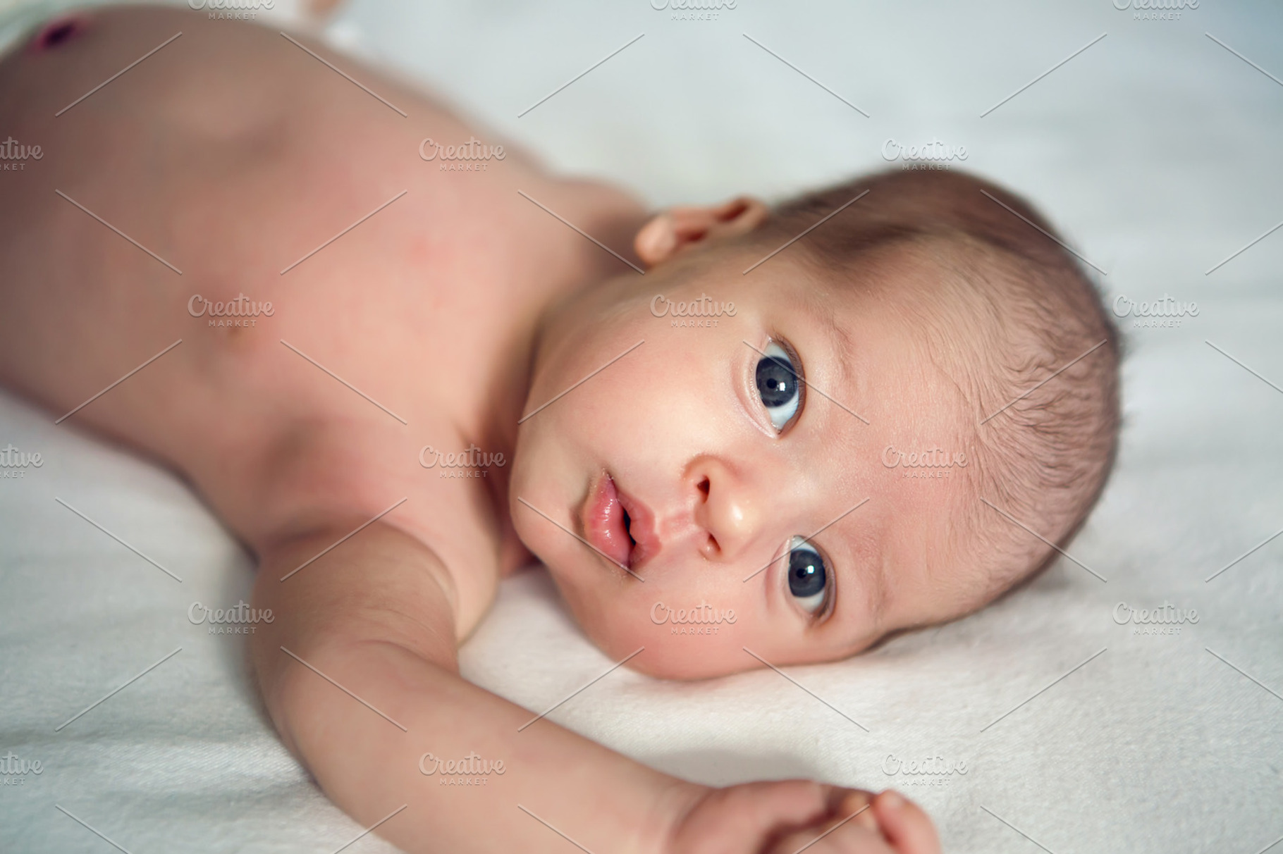 Newborn baby looking at camera stock photo containing newborn and baby, a Person Photo by SaulichPhoto