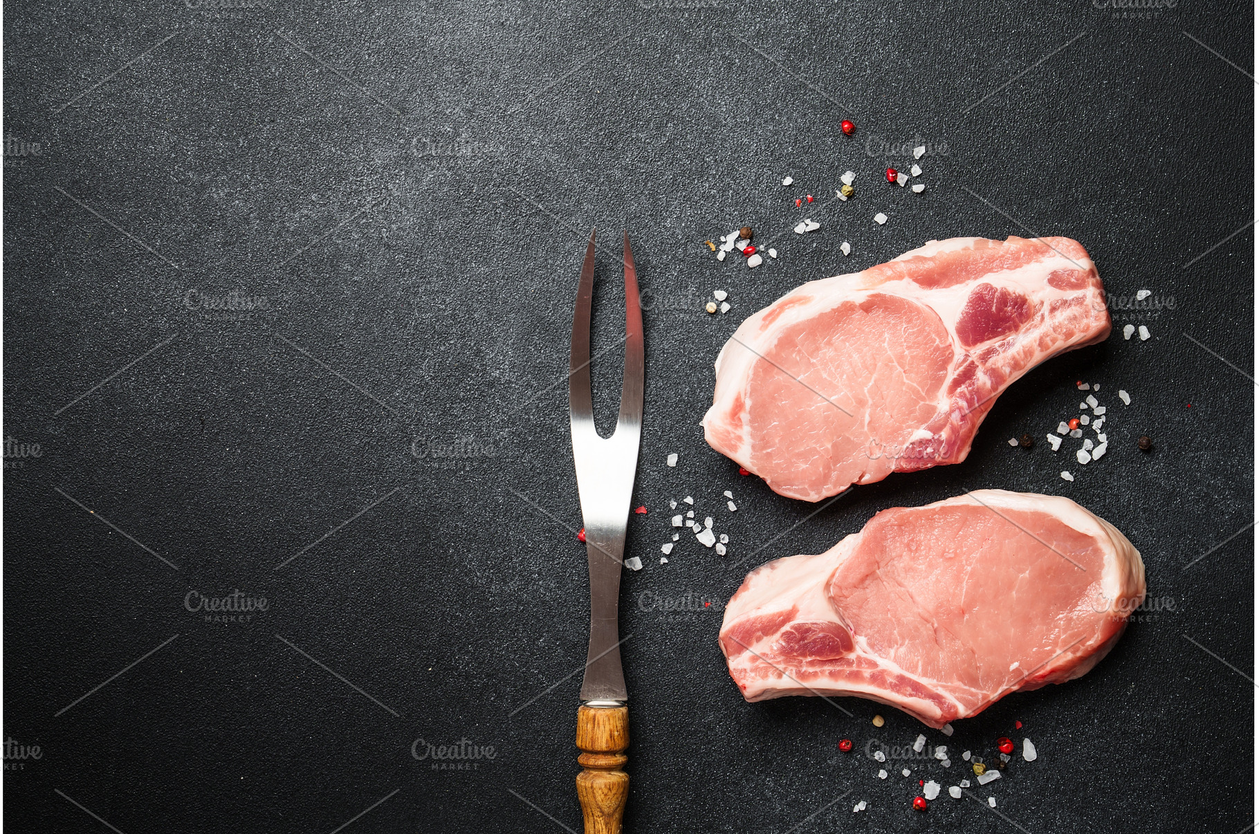 Raw pork meat steaks on black, a Food & Drink Photo by Nadia-nb