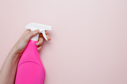Household cleaning and hygiene concept. A womans hand holds the pink product in, a Photo by matucha