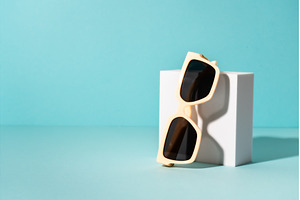 Sunglasses on white podium with, an Abstract Photo by Nadia-nb