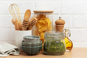 Kitchen utensils, pasta, mung beans and oil creating a cozy culi, a Food & Drink Photo by Olena Rudo
