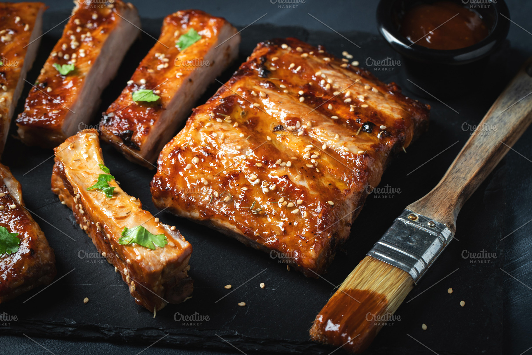 Barbecue pork spare ribs with hot honey chili marinade on black background, a Food & Drink Photo by Budarinphoto