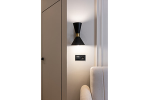 Black wall sconce above modern sofa, an Architecture Photo by wip3out