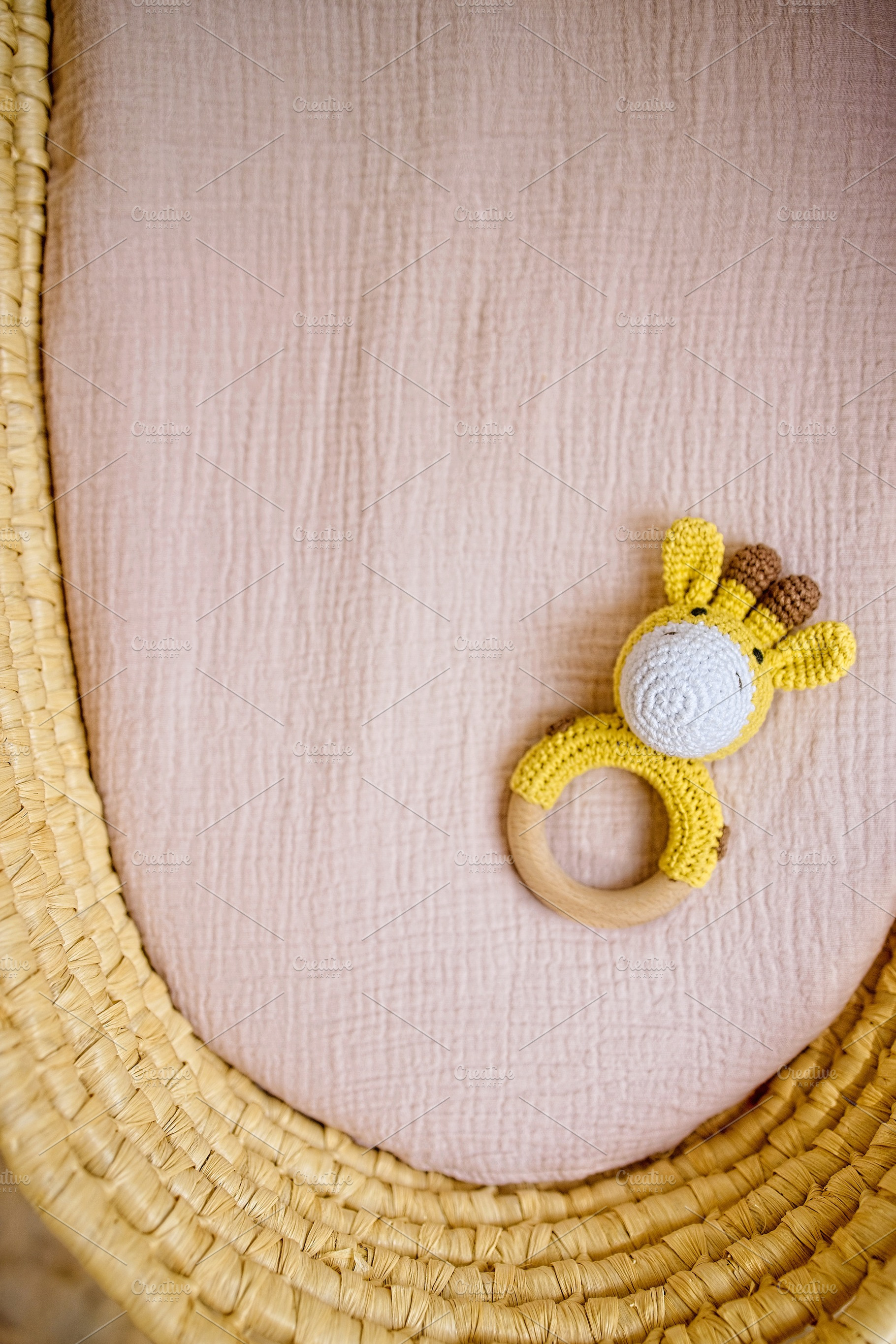 in a basket natural wooden knitted toys for a newborn. View from above, a Beauty & Fashion Photo by TanaCh