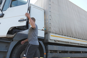 Trucker opens the door and sits down stock photo containing cargo and