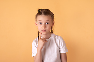 Portrait of a young girl with braids in a white t-shirt, looking, a Person Photo by Ales Munt