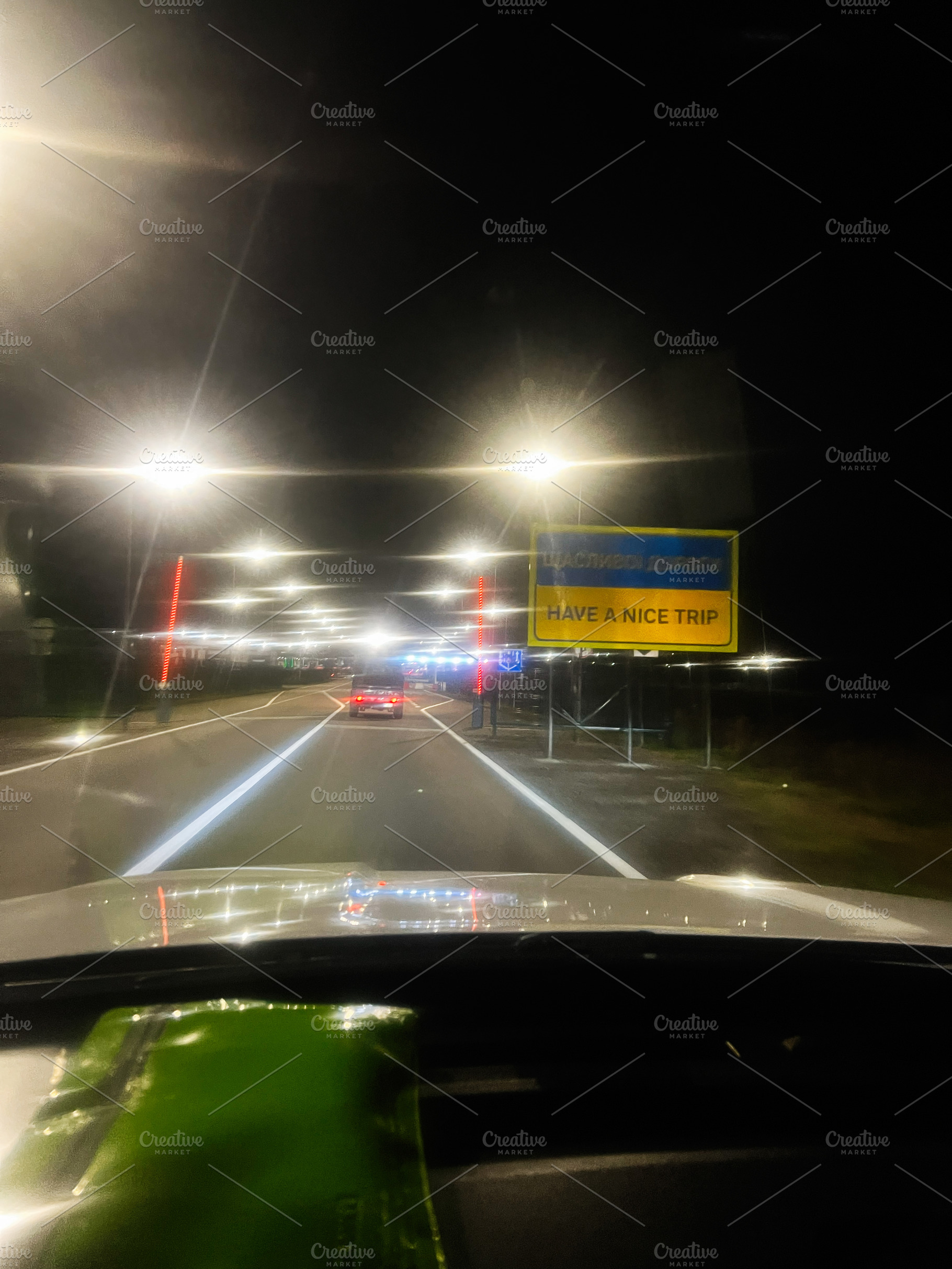 Night drive to the border with bright street lights and a welcoming have a nice, a Photo by AS photostudio