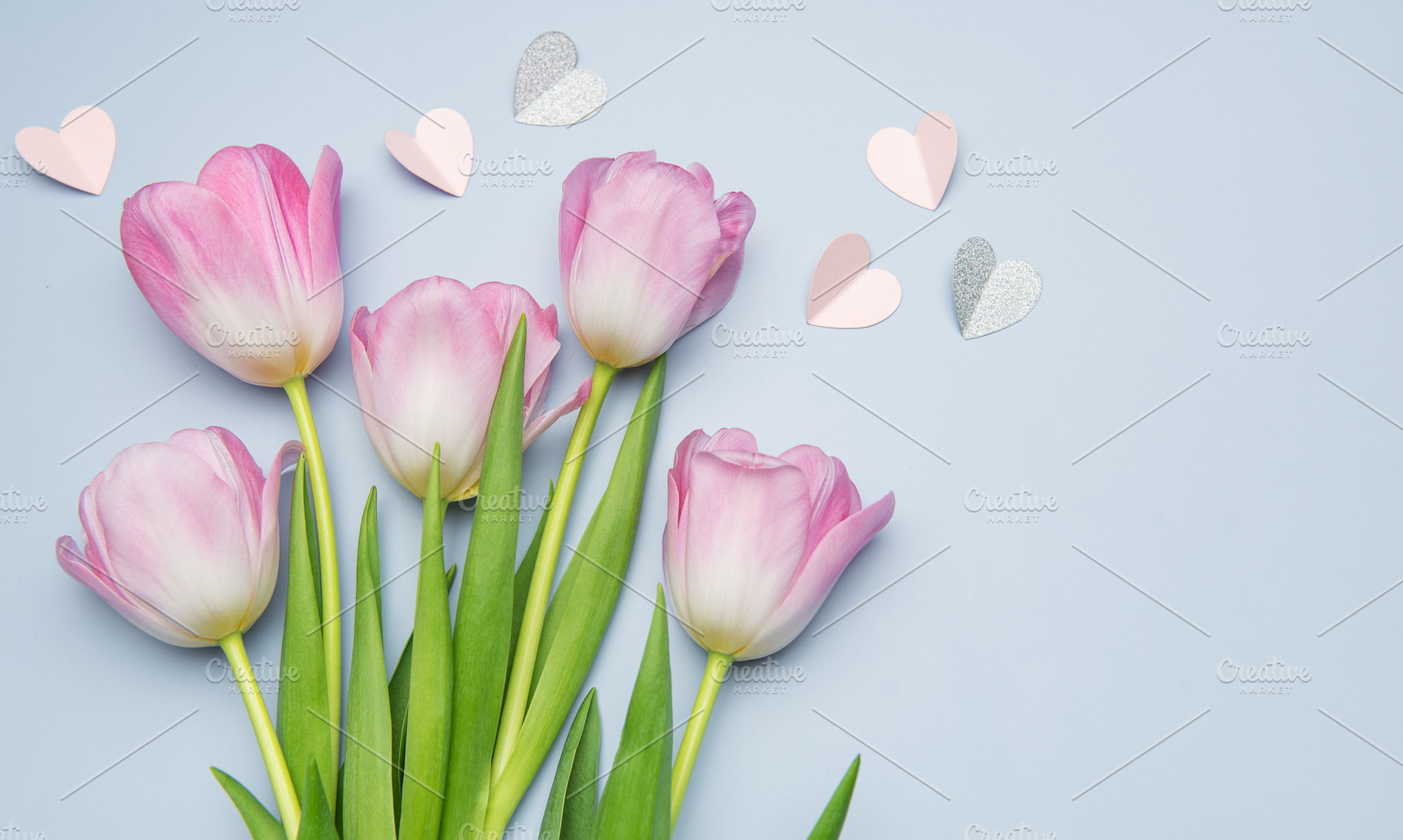 Pink tulips and paper hearts creating a romantic atmosphere, a Holiday Photo by Olena Rudo