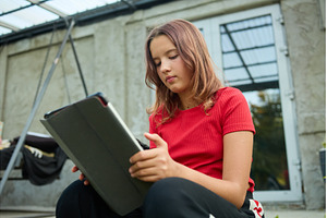 School girl uses tablet while