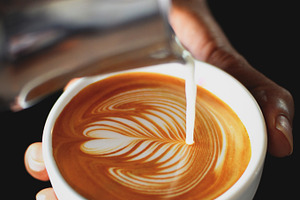 Coffee latte art featuring art, espresso, and wood