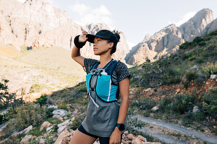 Female hiker standing in valley, a Sports & Recreation Photo by Artem Varnitsin