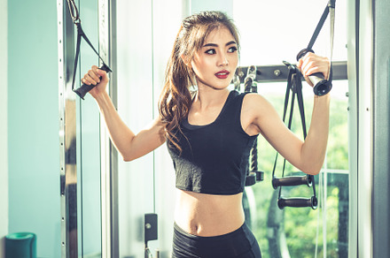 Asian young woman doing elastic rope exercises at cross fitness, a Sports & Recreation Photo by Ministocker