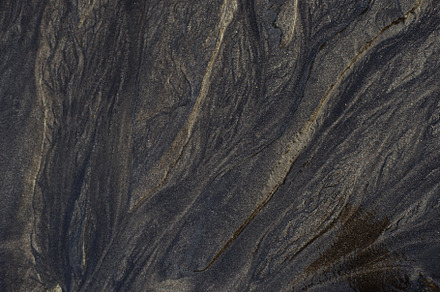 Close up of black rough sandpaper sheet texture use as background containing