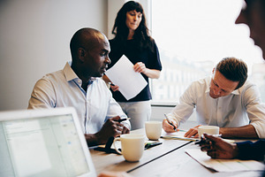Manager and colleagues working in an office