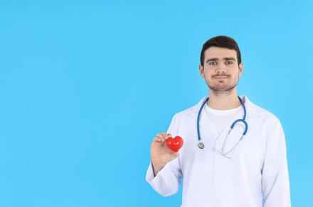 Doctor - intern with heart on blue background, a Person Photo by AtlasStudio PRO