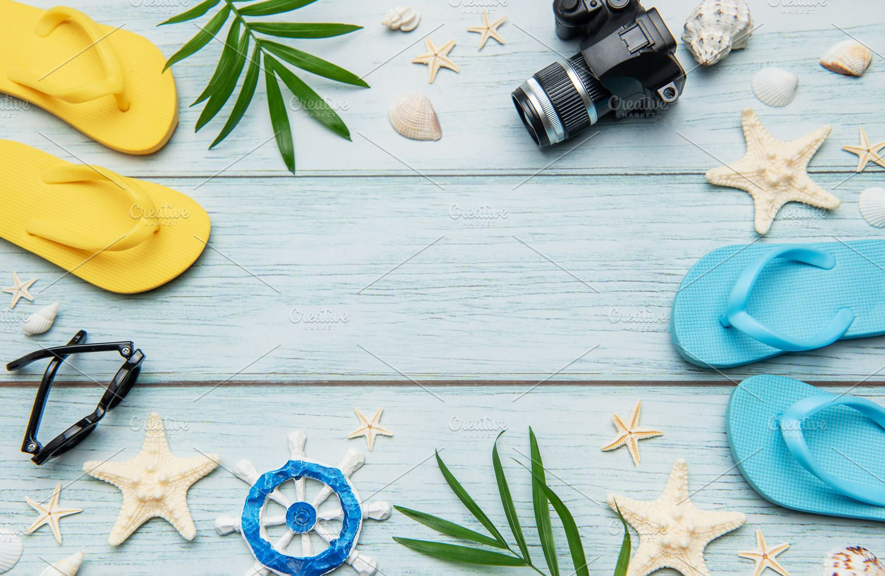 Summer accessories arranged on blue wooden planks create the per, a Holiday Photo by Olena Rudo