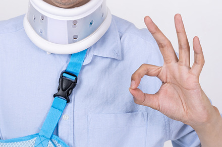 Asian man with broken arm and neck feeling showing okay sign ges