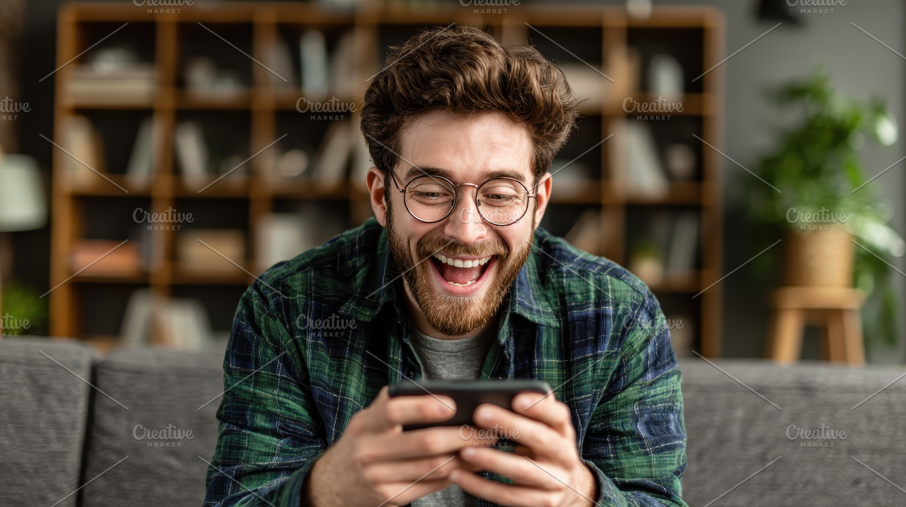 Happy man using smartphone laughing, a Photo by Pixeness Studio