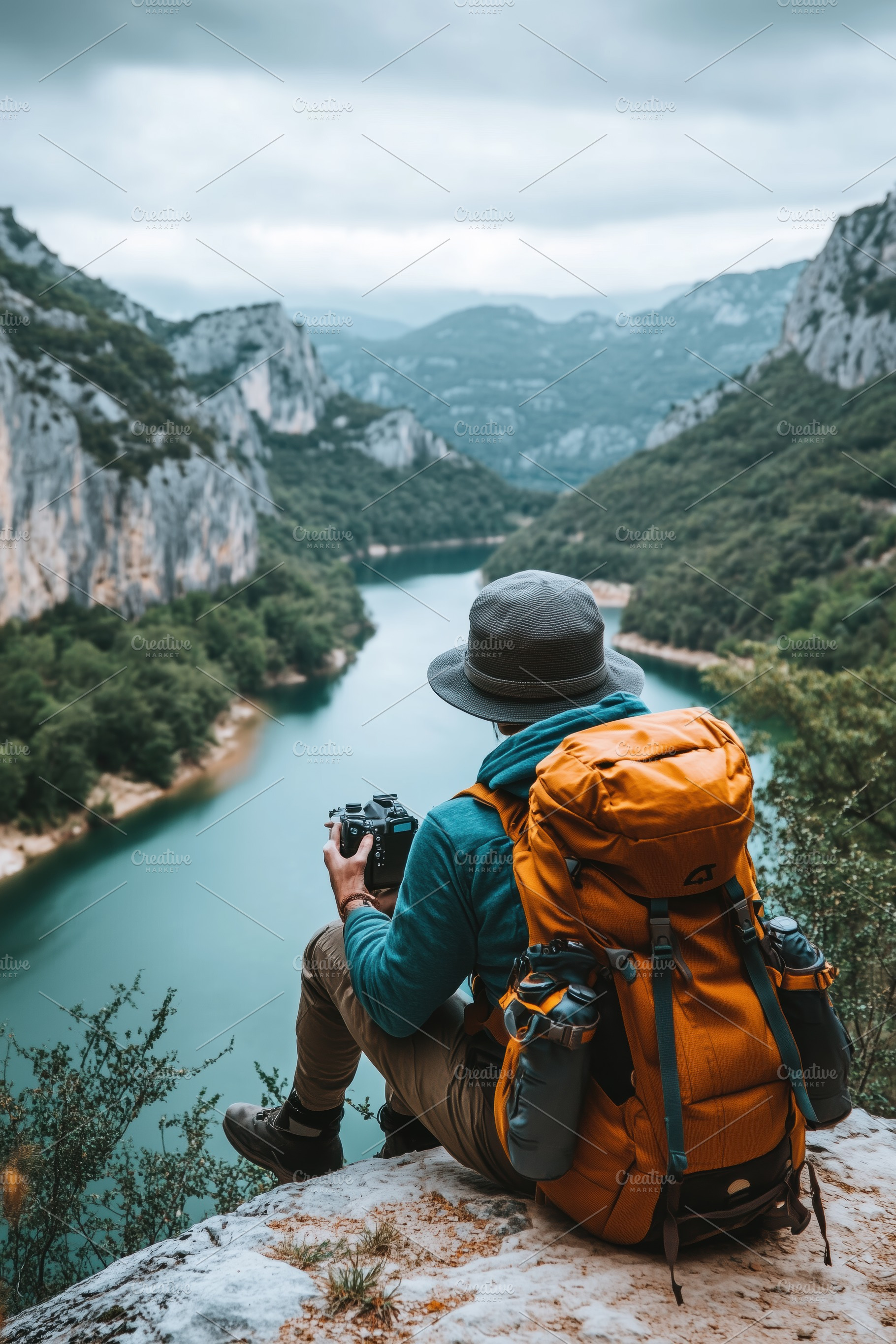 A hiker sits on a rocky ledge overlooking a serene river surrounded by mountain, a Person Photo by Textures & Backgrounds