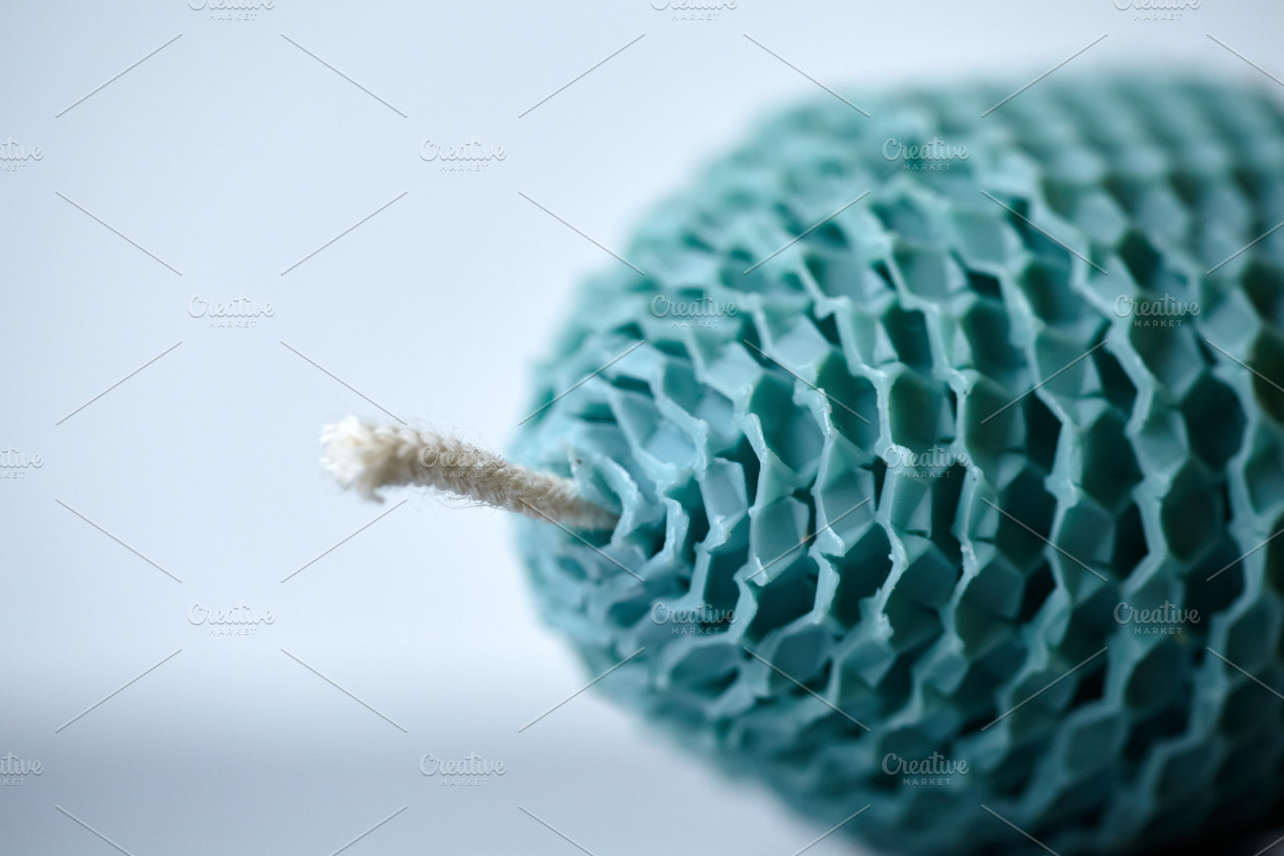 Extreme Macro of a Teal Beeswax Egg Candle Wick on White Background., a Holiday Photo by Rohan Photography