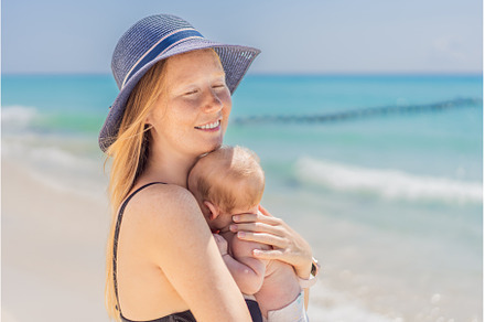 Mother holding her newborn baby by