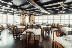 Rustic restaurant interior with tables, a Food & Drink Photo by SkyNext