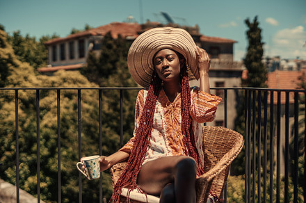 Pretty black woman enjoying the sun, a Person Photo by SkyNext